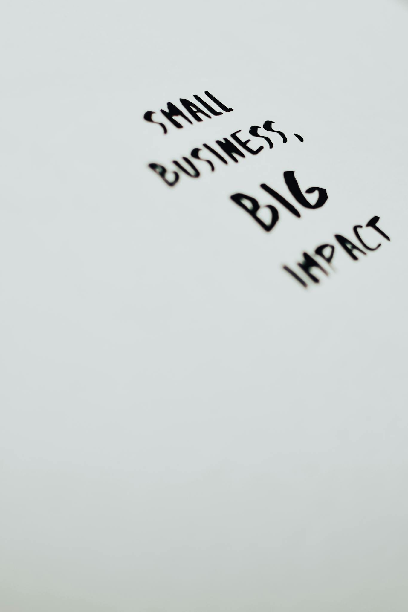 A motivational quote highlighting the impact of small businesses on a minimalist background.